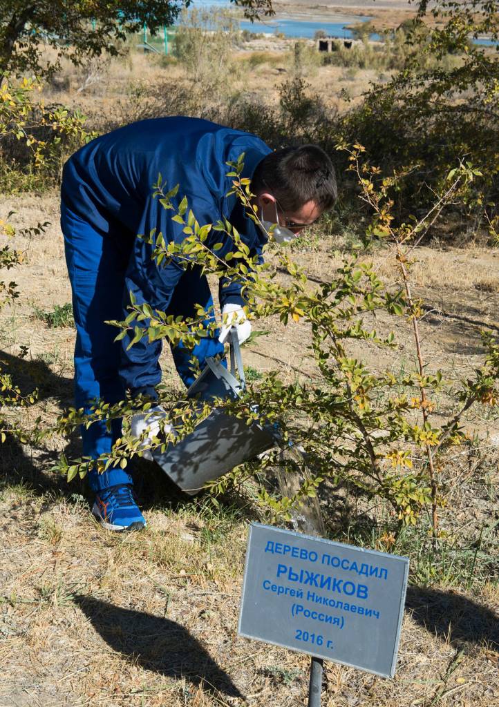 Cosmonaut Sergey Ryzhikov waters a tree