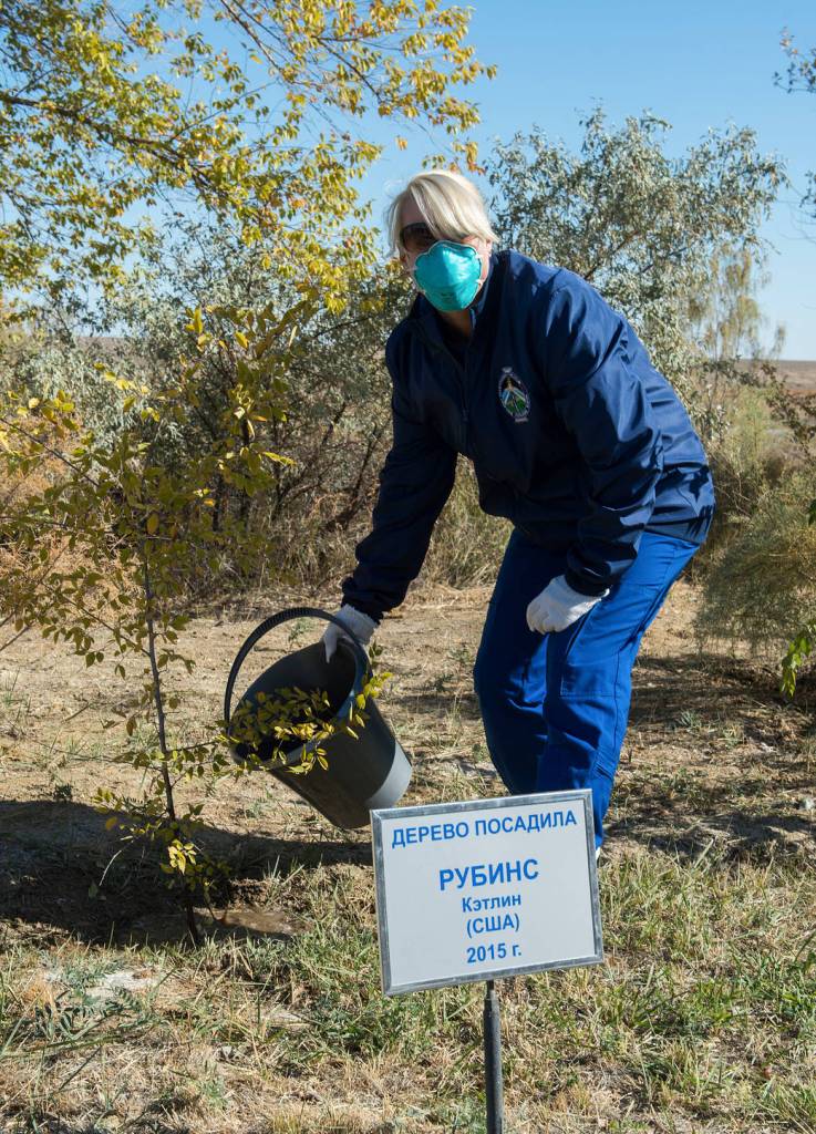 NASA astronaut Kate Rubins waters a tree