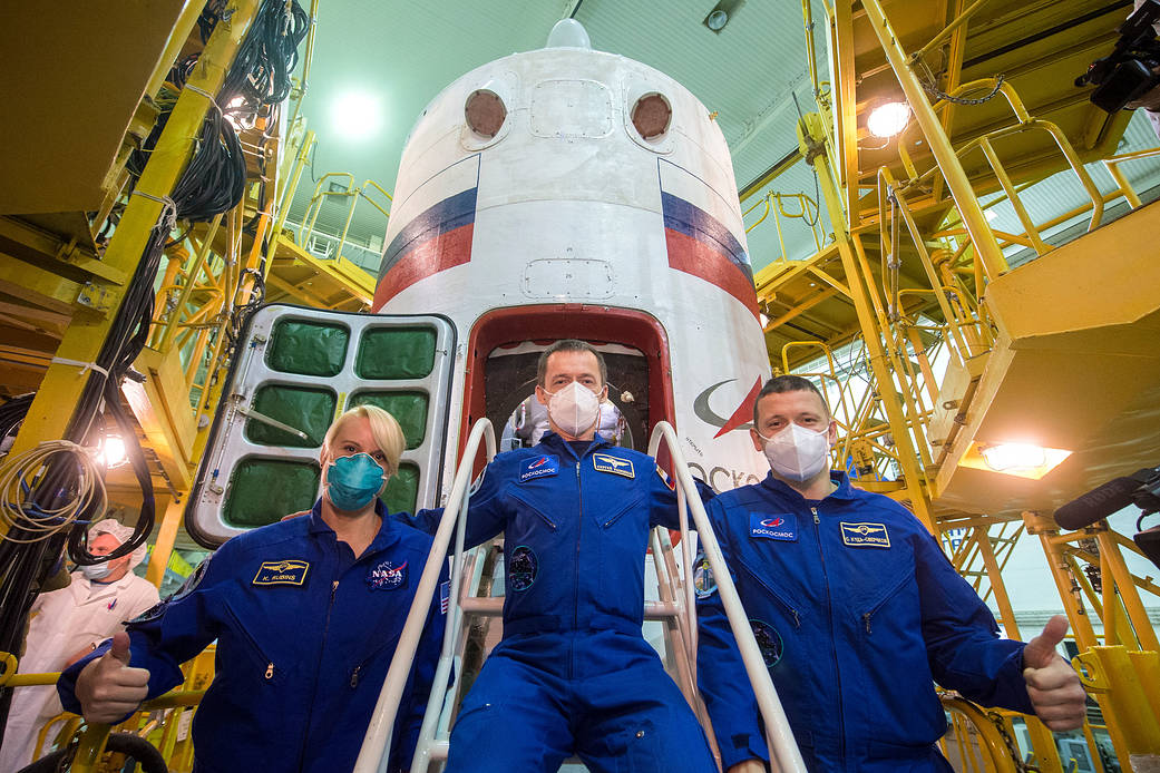 Expedition 64 crew members in front of Soyuz MS-17 spacecraft