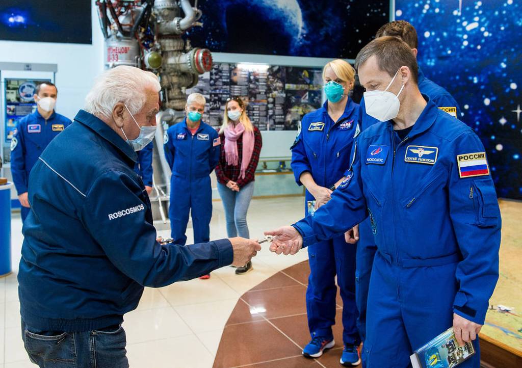 Cosmonaut Sergey Ryzhikov is presented with a souvenir launch key