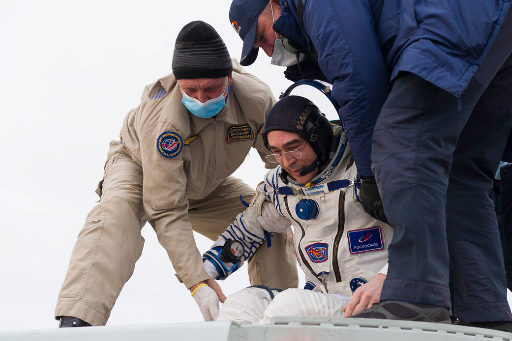 Cosmonaut Anatoly Ivanishin is helped out of the Soyuz MS-16 spacecraft