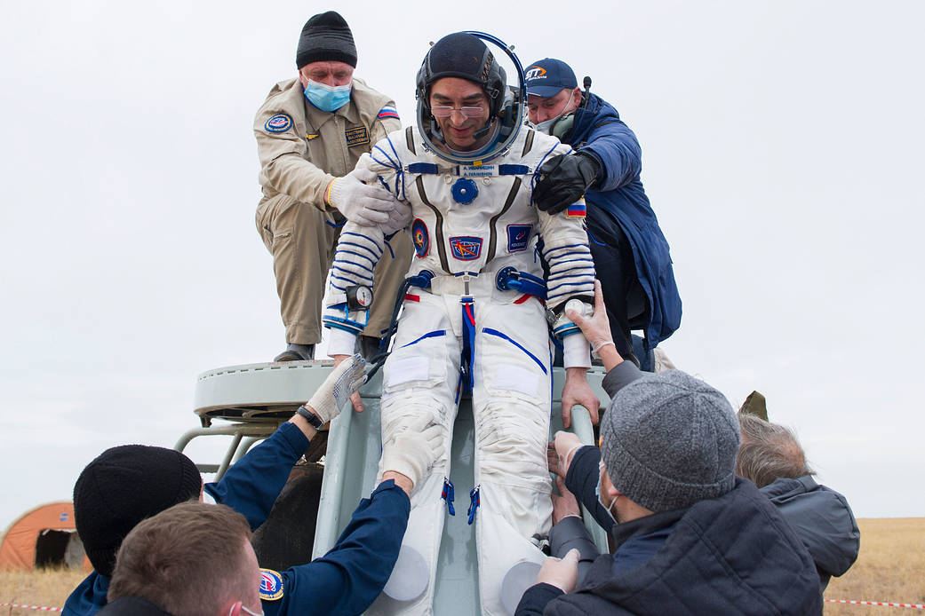 Cosmonaut Anatoly Ivanishin is helped out of the Soyuz MS-16 spacecraft