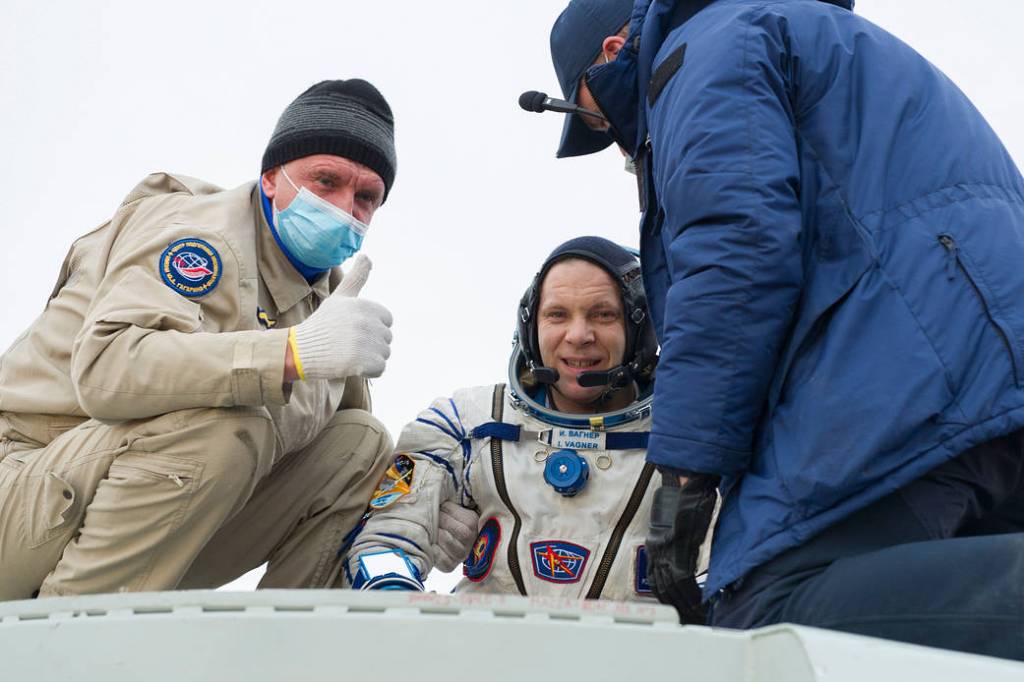 Cosmonaut Ivan Vagner is helped out of the Soyuz MS-16 spacecraft