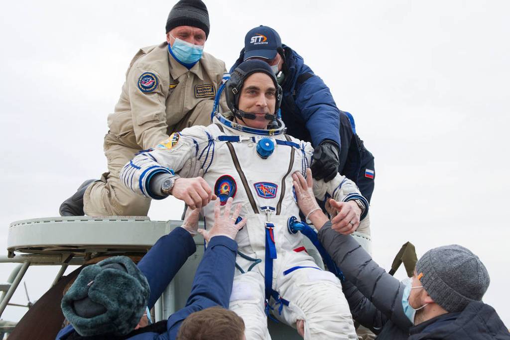 Astronaut Chris Cassidy is helped out of the Soyuz MS-16 spacecraft