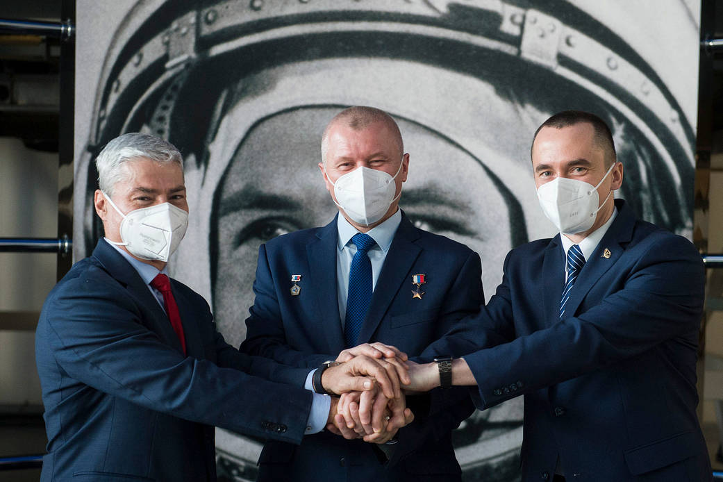 Expedition 65 crew members pose for a photo at a press conference