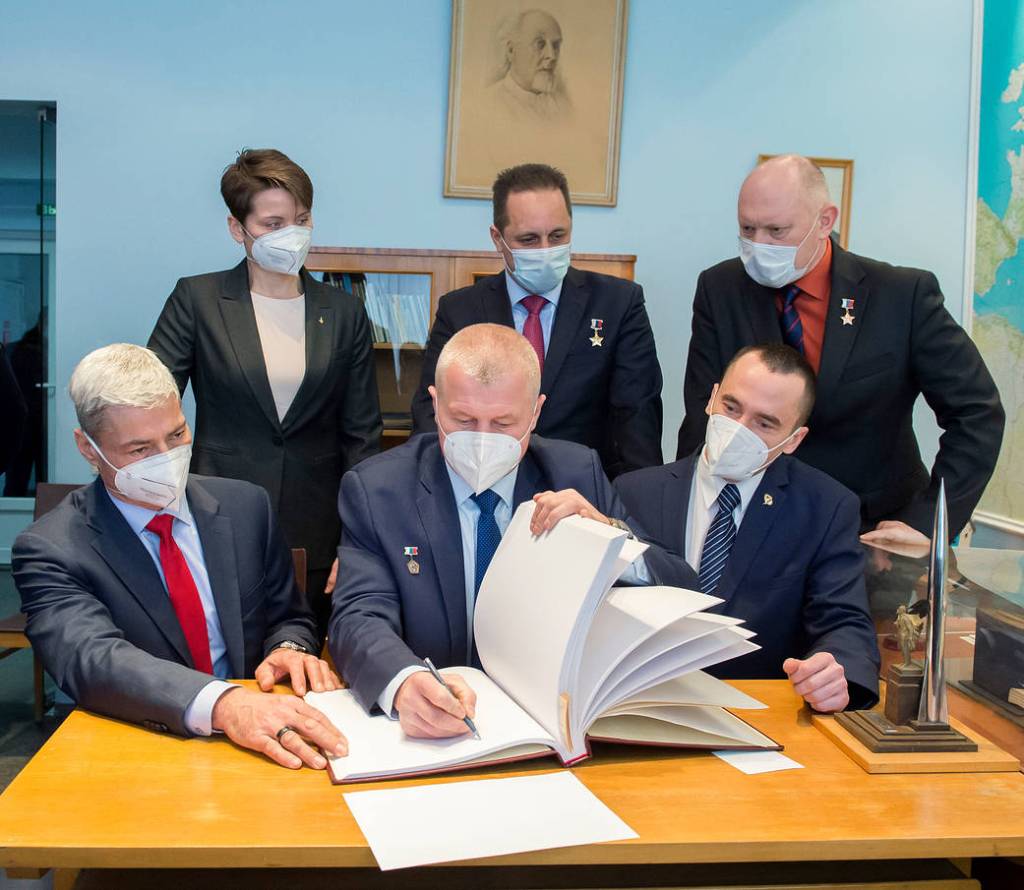 Oleg Novitskiy signs guest book at the Memorial study of Yuri Gagarin