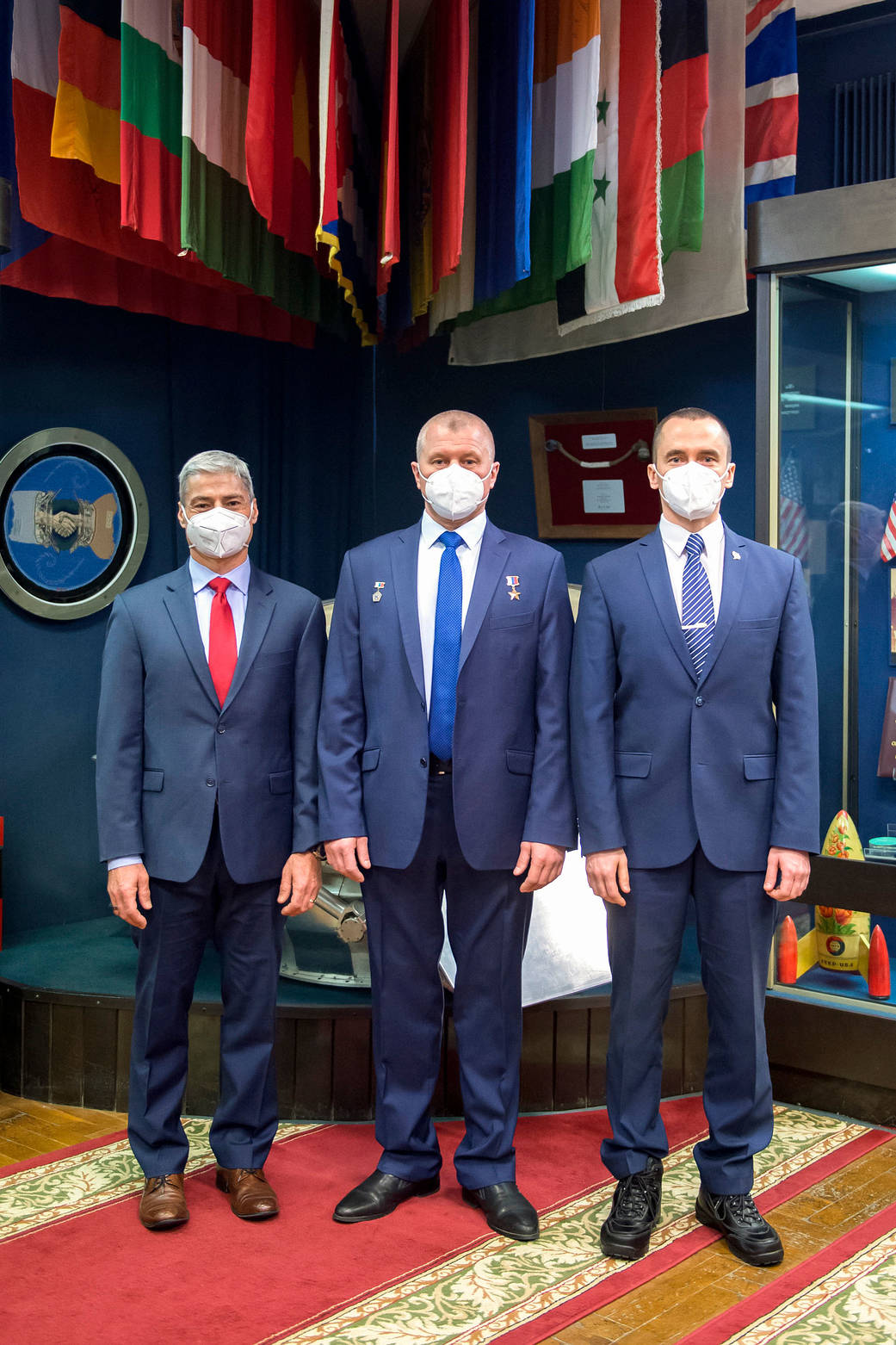 Expedition 65 crew members pose for a photo after a press conference