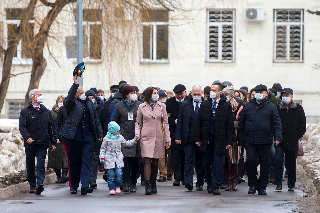 Expedition 65 prime crew members walking with friends and family