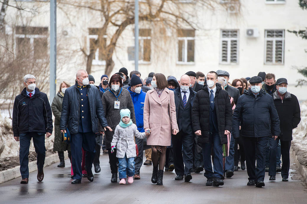 Expedition 65 prime crew members walking with friends and family