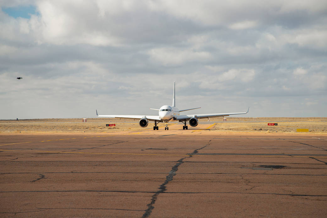 The airplane carrying Expedition 65 crew members arrives in Baikonur