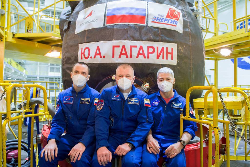 Expedition 65 prime crew members pose for a photo in front of the Soyuz