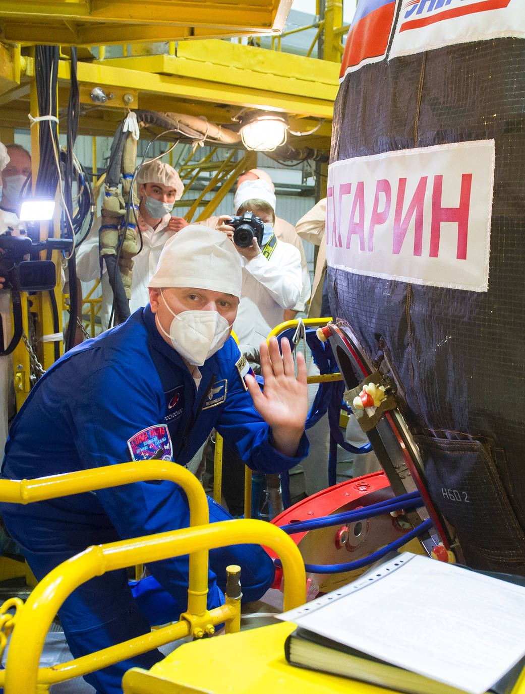 Cosmonaut Oleg Novitskiy is seen heading inside the Soyuz