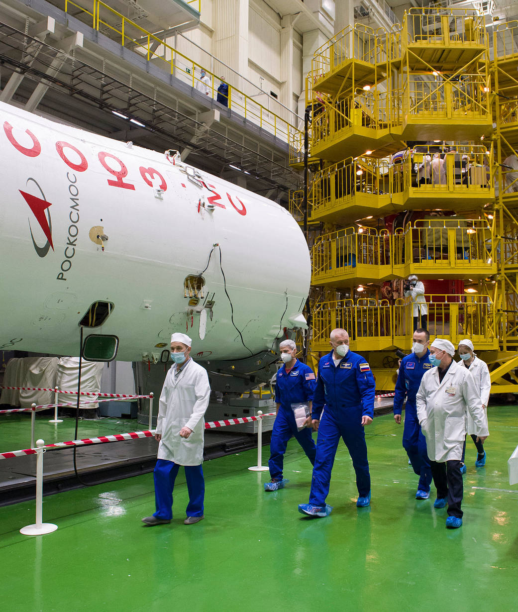 Expedition 65 prime crew members touring building 254 during a fit check