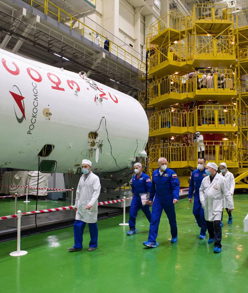 Expedition 65 prime crew members touring building 254 during a fit check