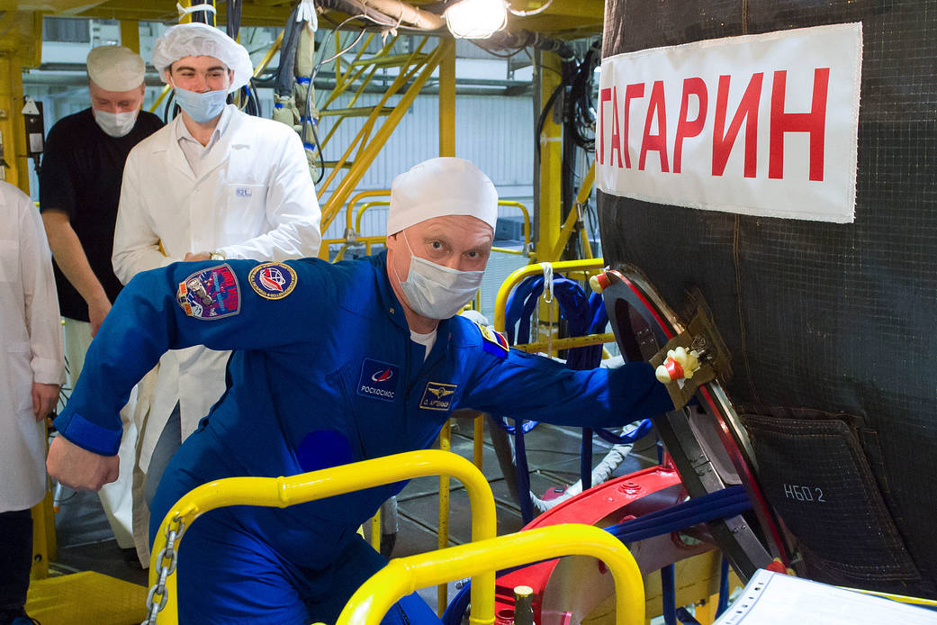 Oleg Artemyev of Roscosmos heads inside the Soyuz