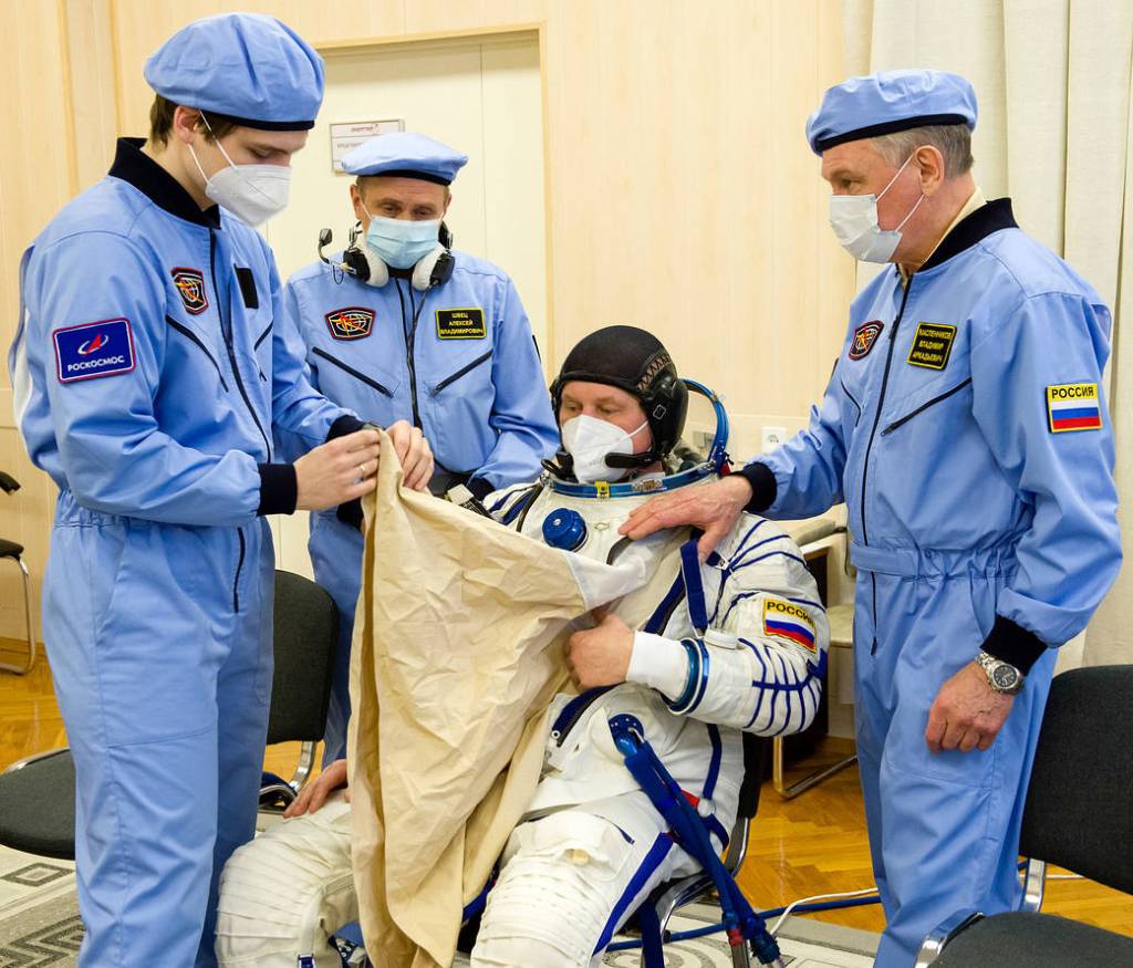 Oleg Novitskiy of Roscosmos dons his Sokol suit during the fit check
