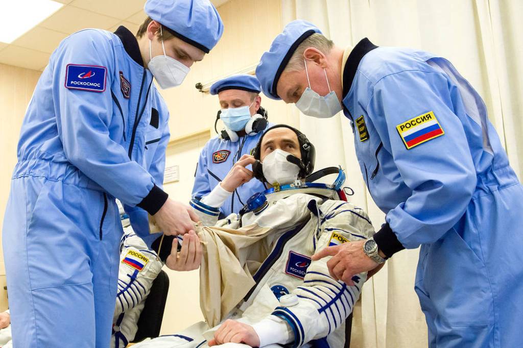 Pyotr Dubrov of Roscosmos dons his Sokol suit during the fit check