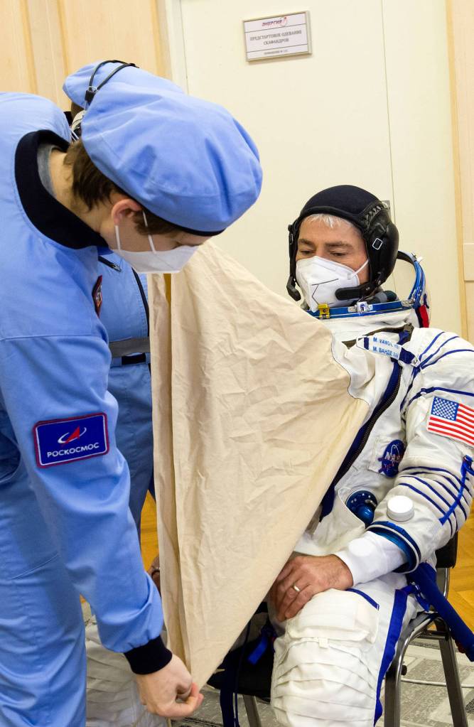 NASA astronaut Mark Vande Hei dons his Sokol Suit during a fit check
