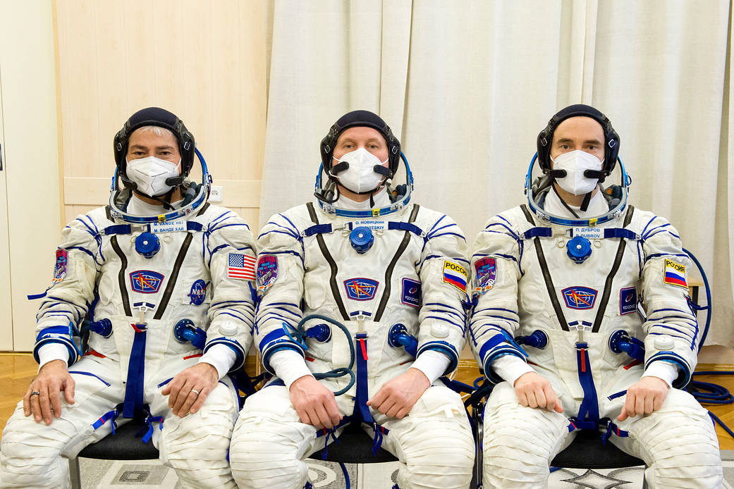 Expedition 65 prime crew members after donning their Sokol suits