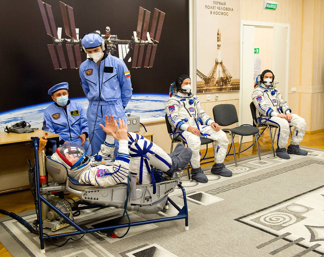 Oleg Novitskiy of Roscosmos has his Sokol suit pressure checked