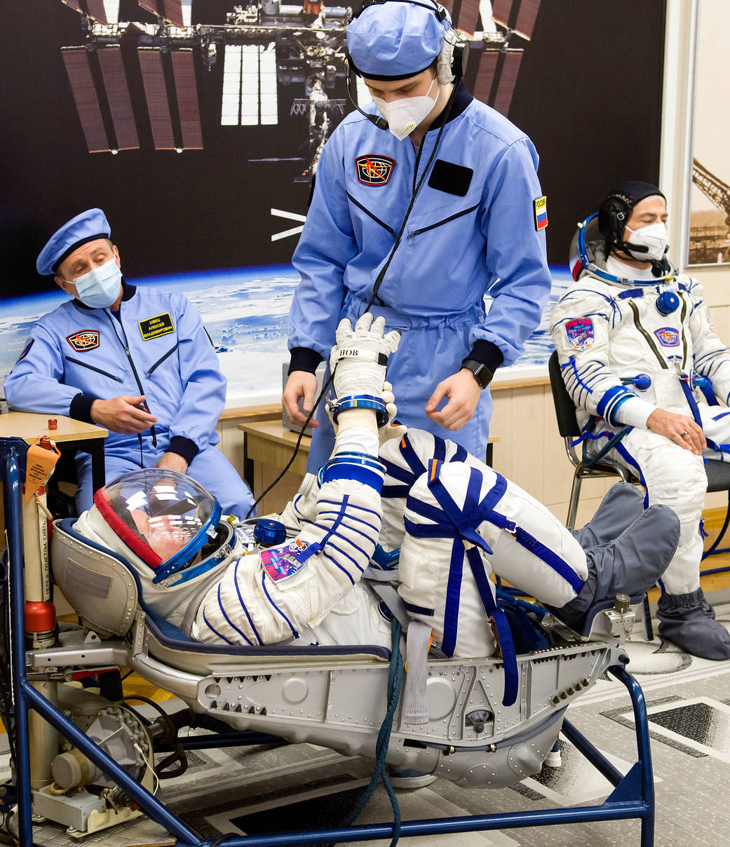 Oleg Novitskiy of Roscosmos has his Sokol suit pressure checked