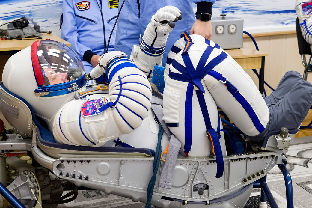 Oleg Novitskiy of Roscosmos has his Sokol suit pressure checked