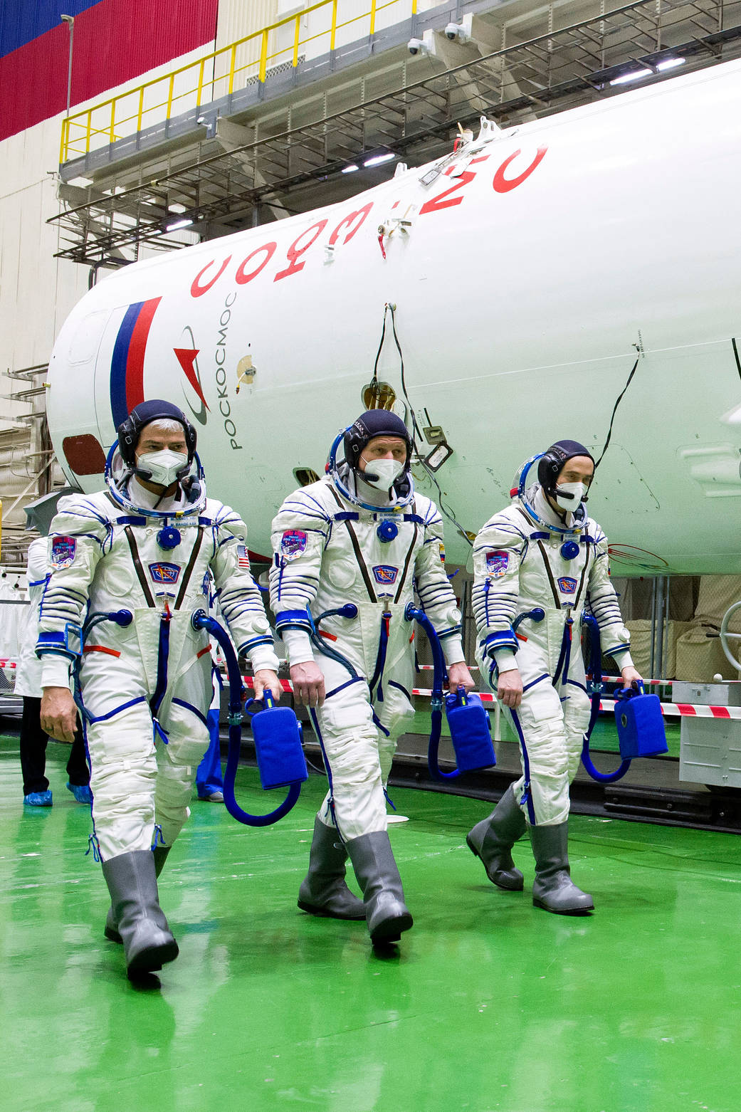Expedition 65 prime crew members walk through Building 254