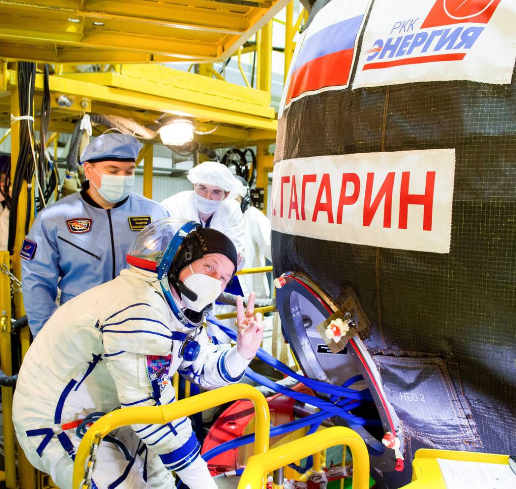Oleg Novitskiy of Roscosmos gestures as he heads inside the Soyuz