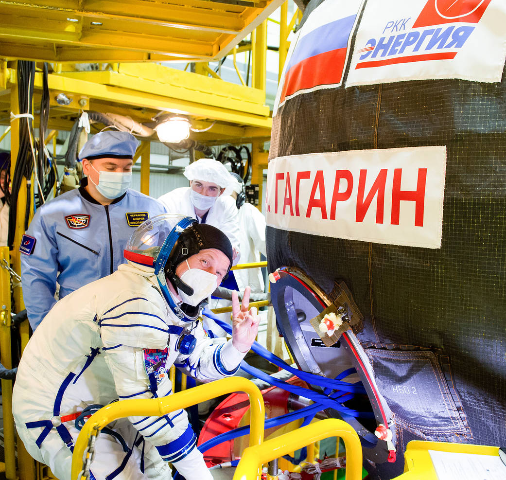 Oleg Novitskiy of Roscosmos gestures as he heads inside the Soyuz