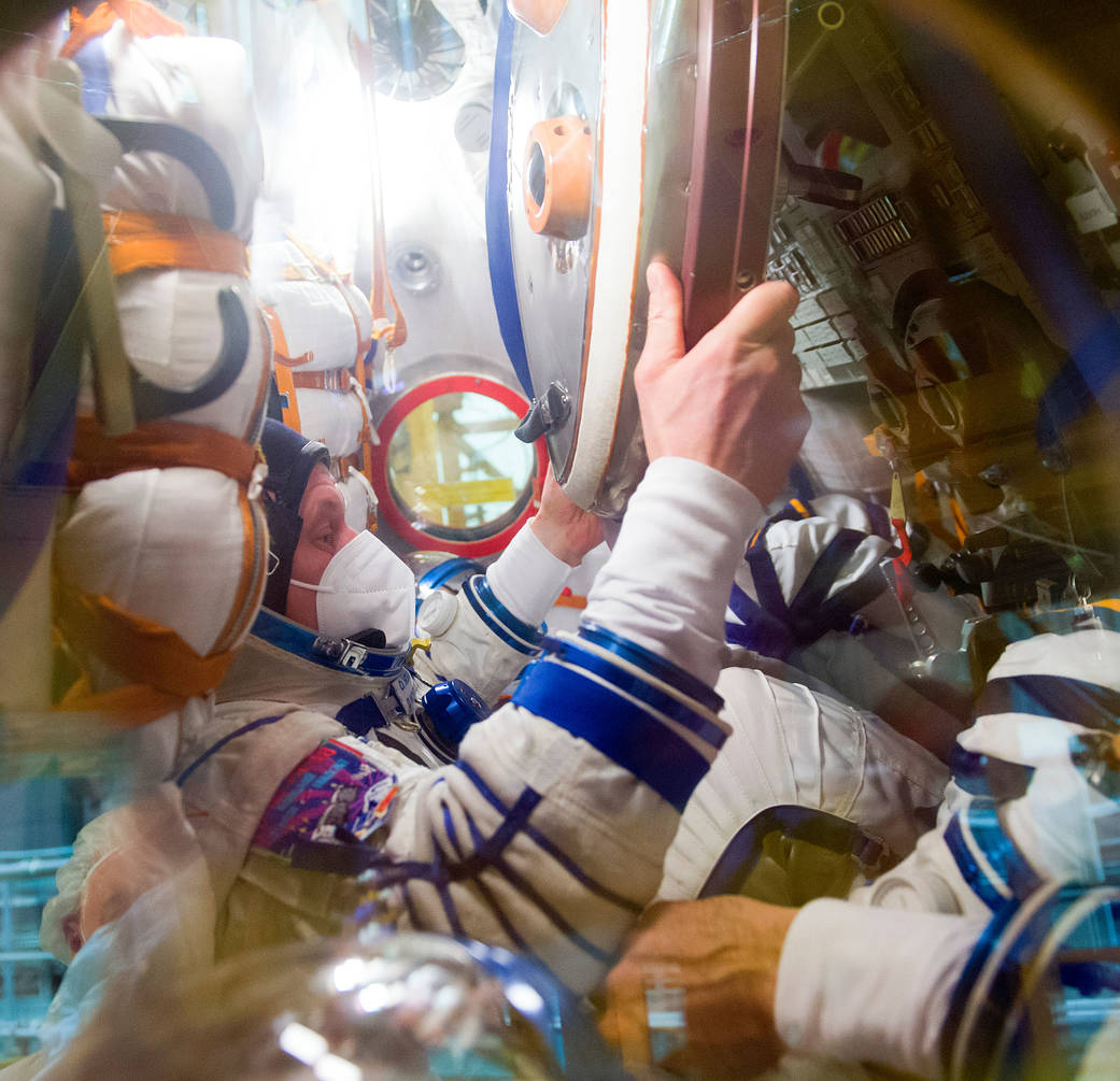 Oleg Novitskiy of Roscosmos inside the Soyuz during a fit check