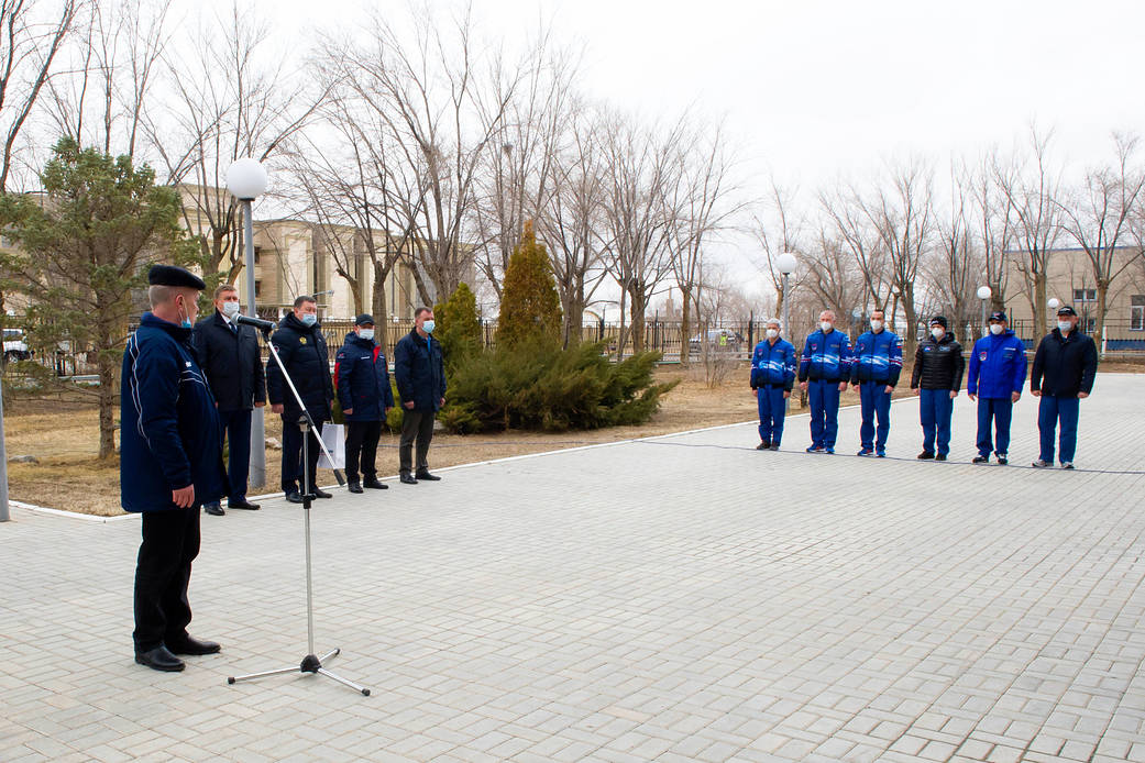 Expedition 65 prime and backup crew members just after raising the flags