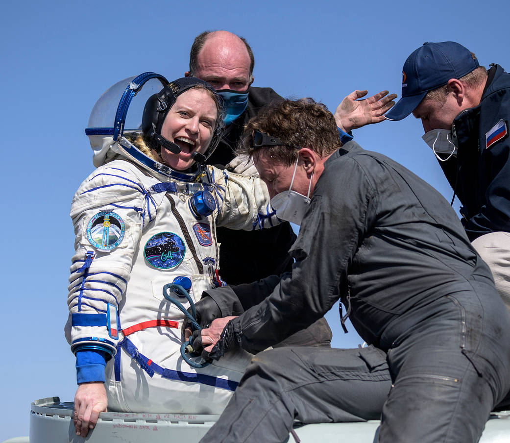 Astronaut Kate Rubins is helped out of the Soyuz MS-17 spacecraft