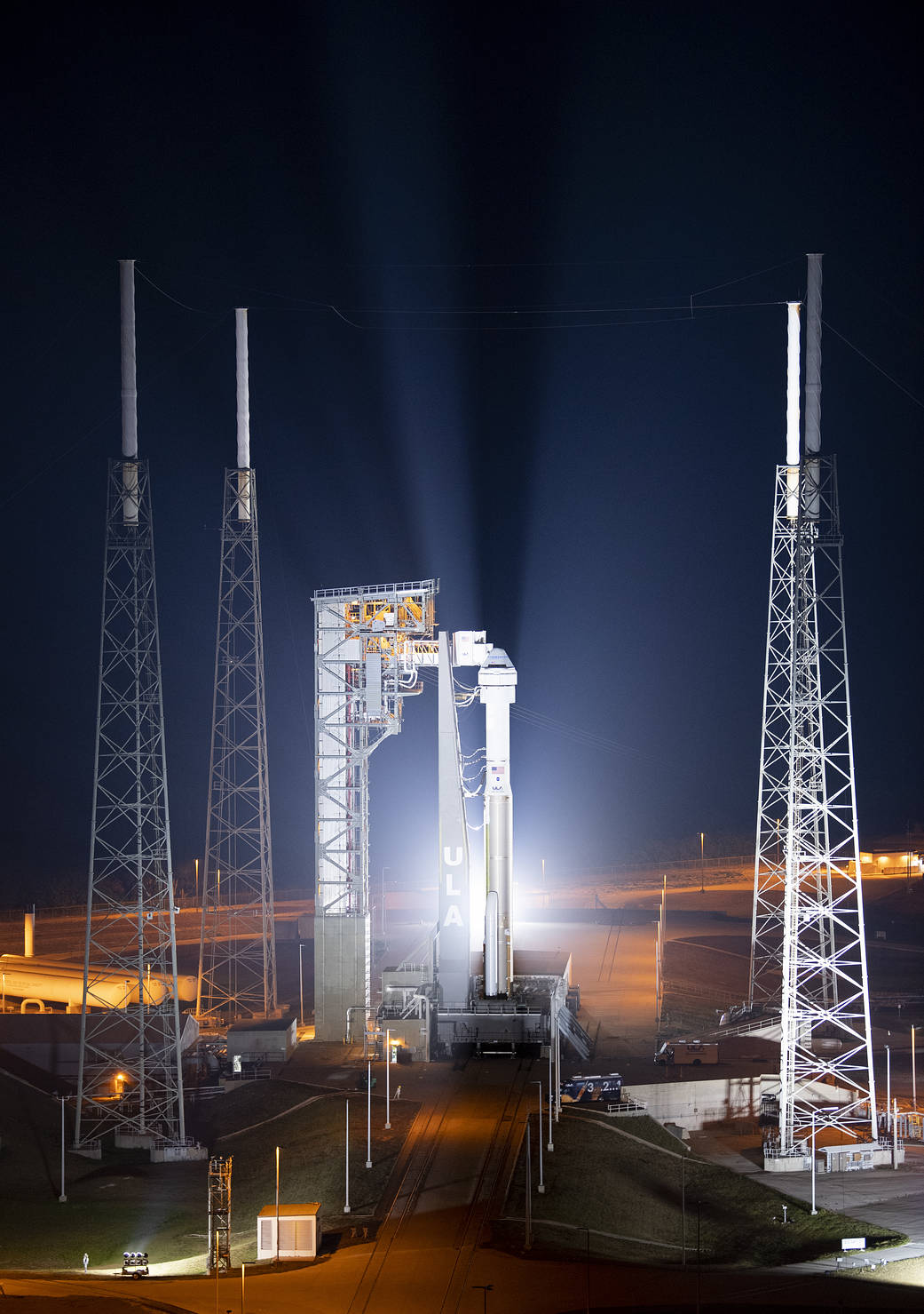 A United Launch Alliance Atlas V rocket with Boeing’s CST-100 Starliner spacecraft aboard is seen illuminated by spotlights on the launch pad at Space Launch Complex 41 ahead of the Orbital Flight Test-2 mission.