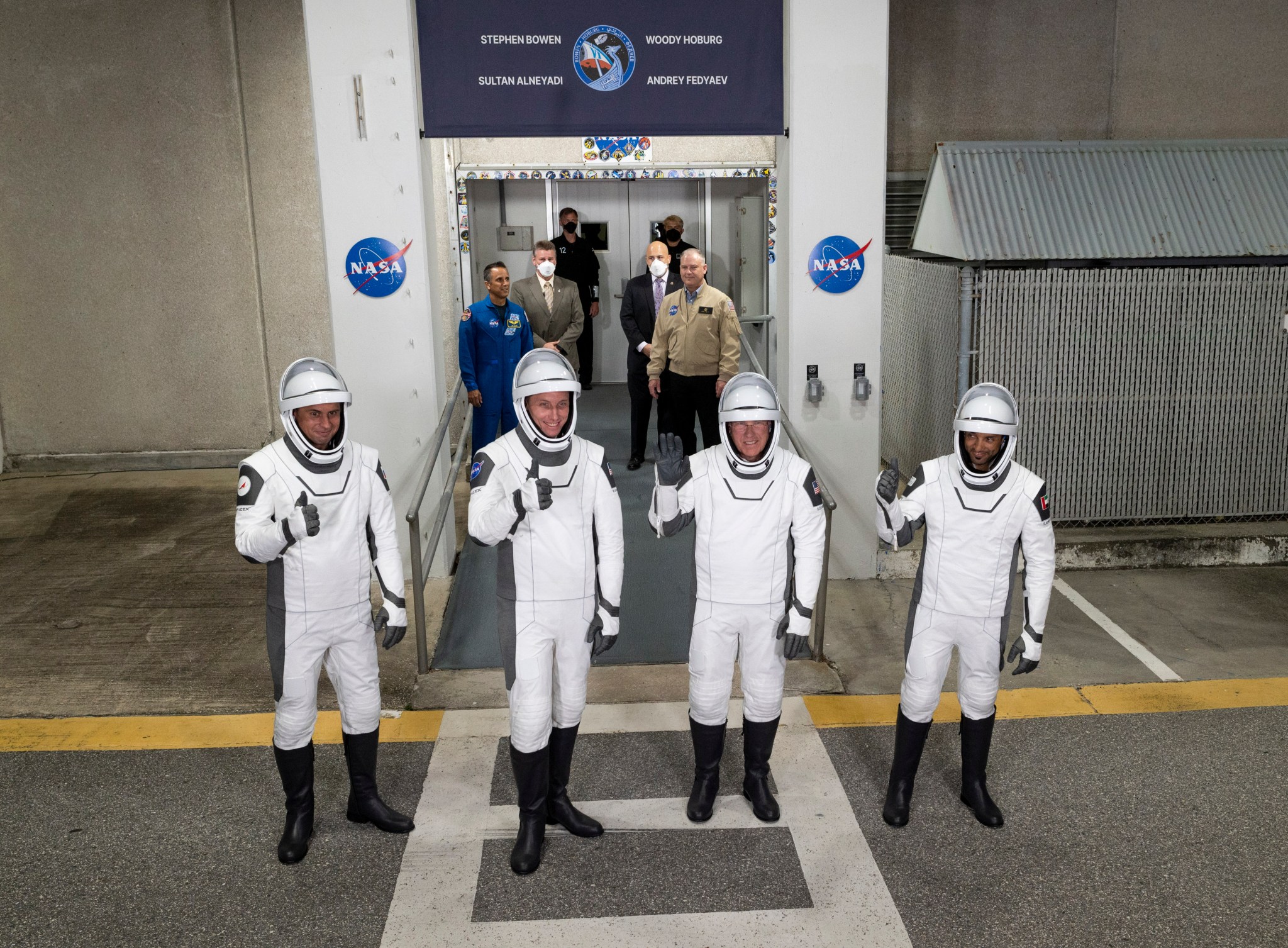 Roscosmos cosmonaut Andrey Fedyaev, left,NASA astronaut Warren “Woodyu0022 Hoburg, second from left, NASA astronaut Stephen Bowen, second from right, and UAE (United Arab Emirates) astronaut Sultan Alneyadi, right, wearing SpaceX spacesuits, pose as they prepare to depart the Neil A. Armstrong Operations and Checkout Building for Launch Complex 39A at NASA’s Kennedy Space Center in Florida.