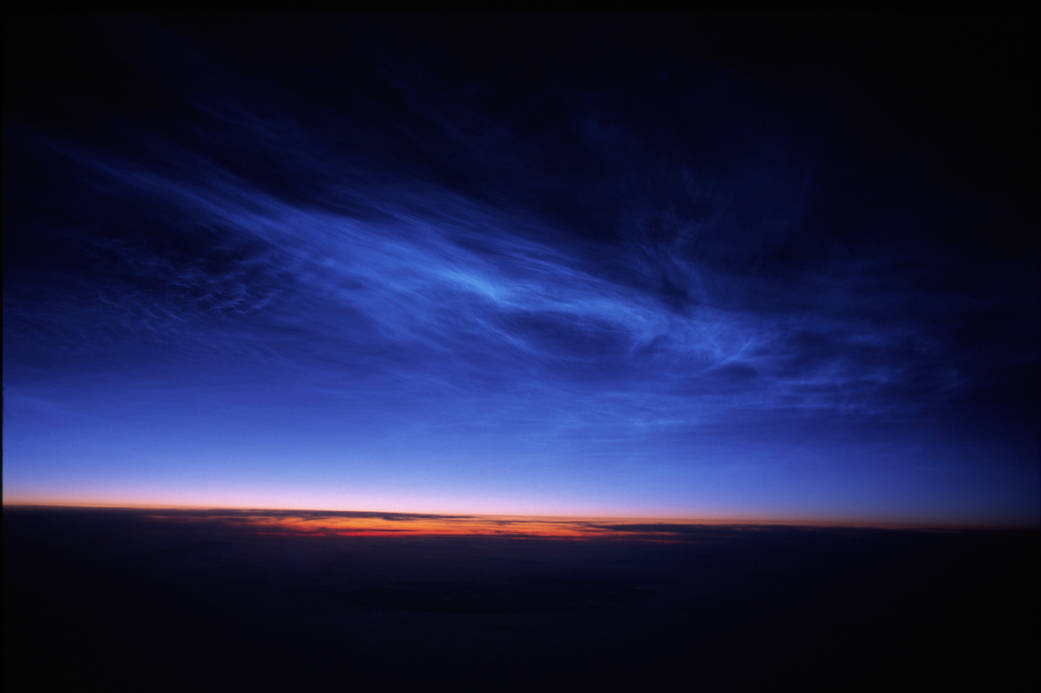 Noctilucent Clouds taken from 36,000 feet above the South of Nunivak Island, Alaska on June 20, 2006.