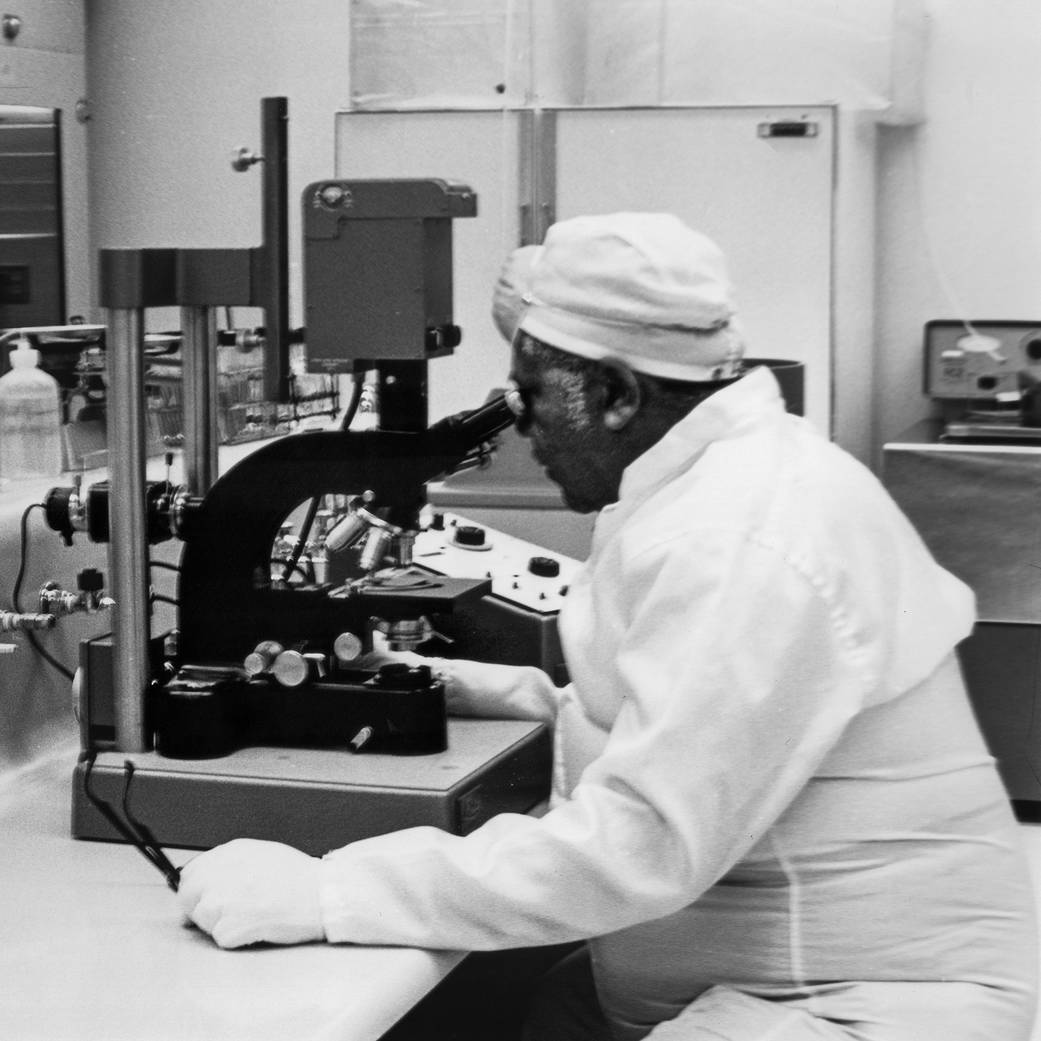 Chemist Oscar Whitfield examines an Apollo lunar sample in the fall of 1969 at NASA Ames’ Research Center