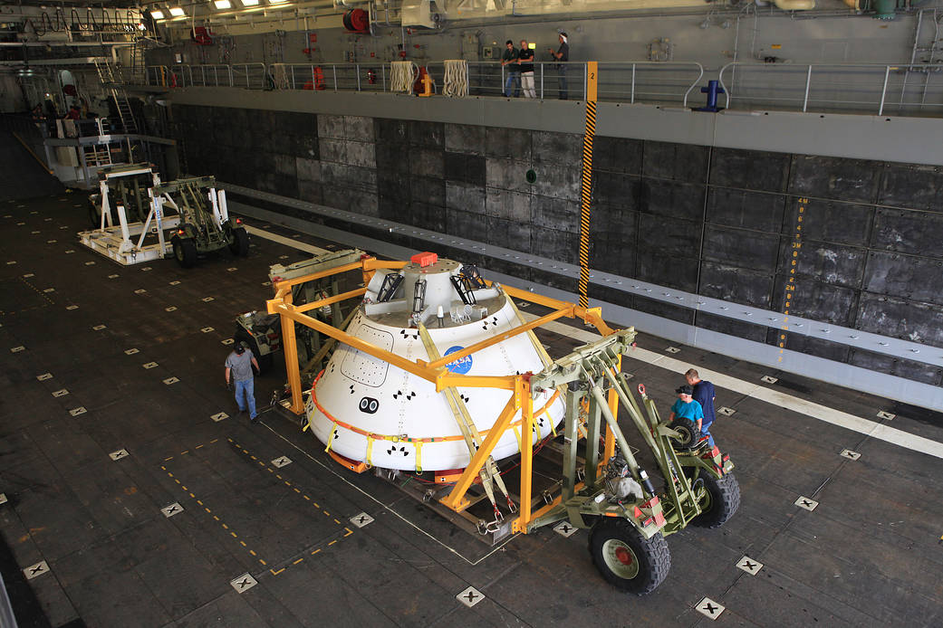 Orion spacecraft model on large cart on ship's deck