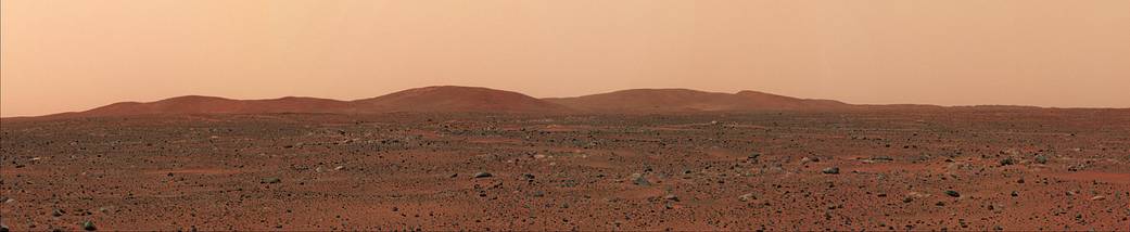 Wide view of Mars horizon from surface with hills in distance