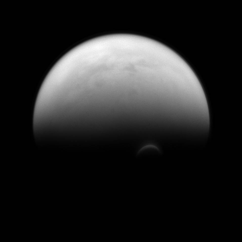 The sunlit edge of Titan's south polar vortex stands out distinctly against the darkness of the moon's unilluminated hazy atmosp