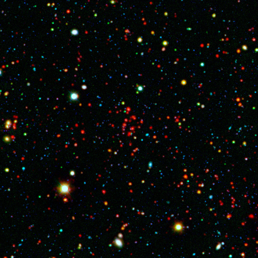 The collection of red dots seen near the center of this image show one of several very distant galaxy clusters 