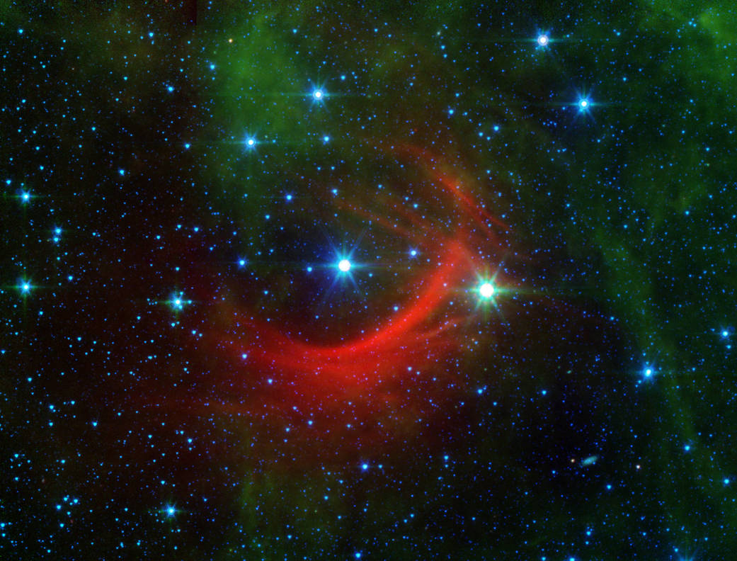 The red arc in this infrared image from NASA's Spitzer Space Telescope is a giant shock wave, created by a speeding star known a