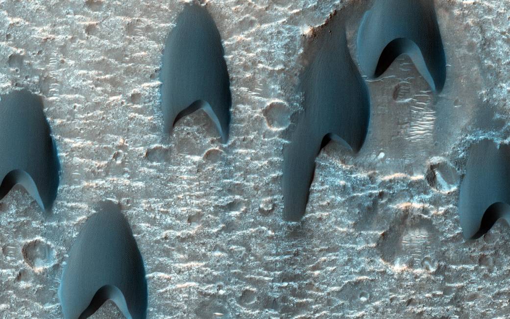 In this image of a dune field on Mars in a large crater near Mawrth Vallis, some of the dunes appear to be in a V-shaped formati