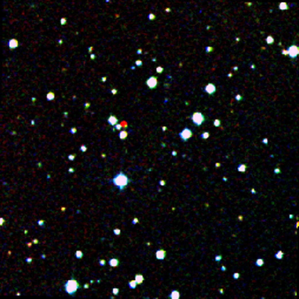 A nearby star stands out in red in this image from the Second Generation Digitized Sky Survey