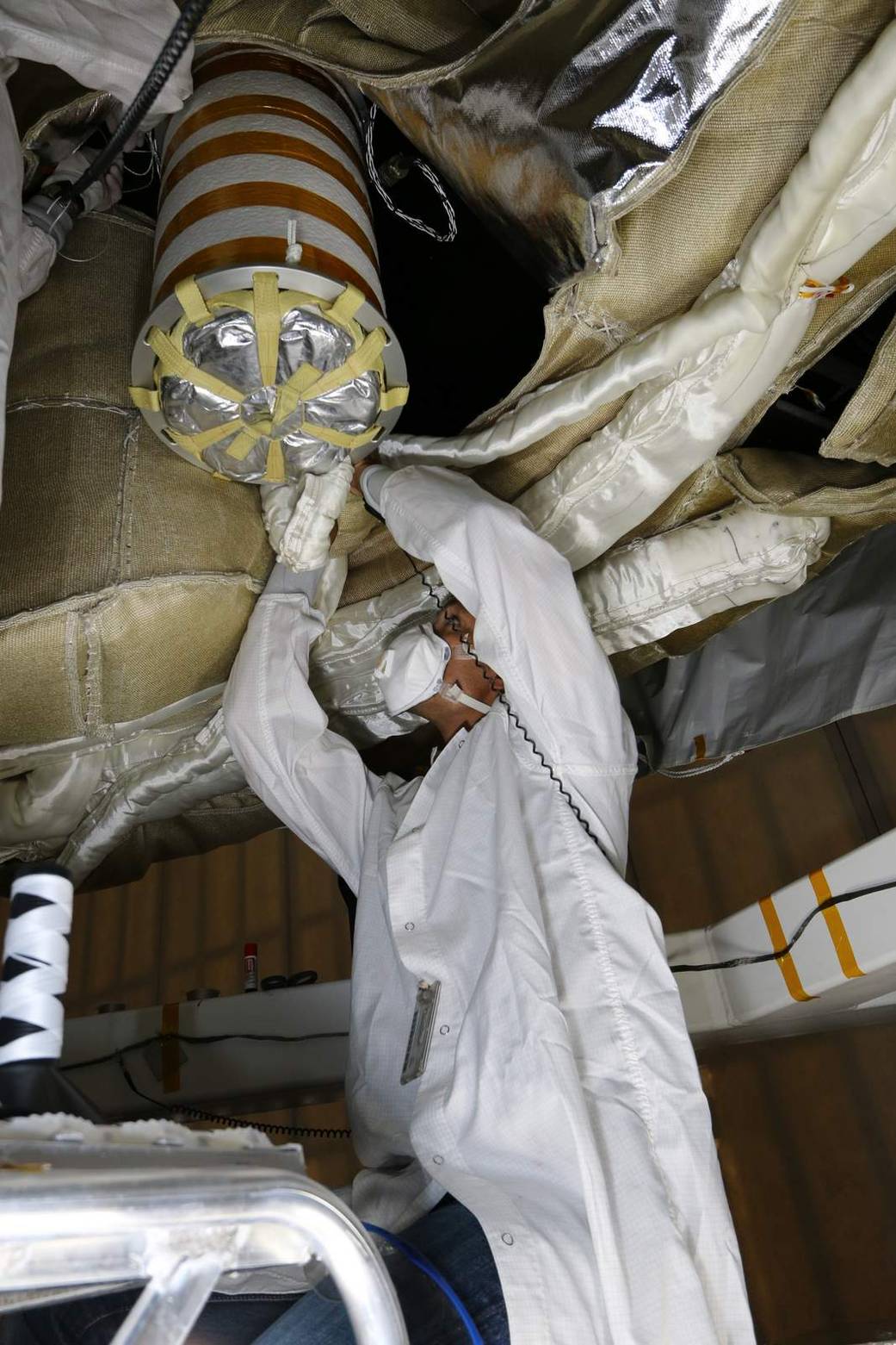 An engineer works on the Parachute Deployment Device of the Low Density Supersonic Decelerator test vehicle 