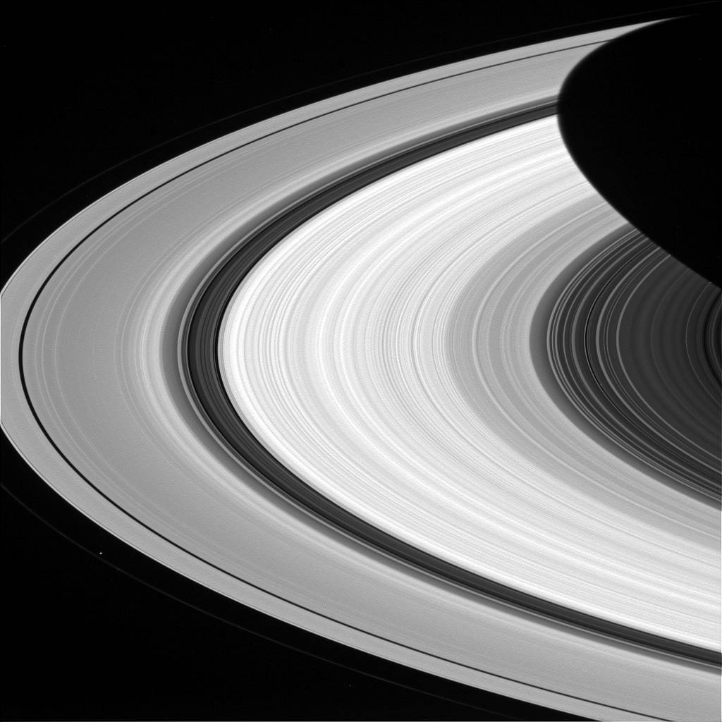 Arc of rings on one side of Saturn in grayscale