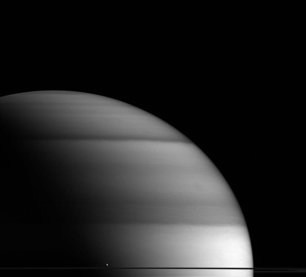 The water-world Enceladus appears here to sit atop Saturn's rings 