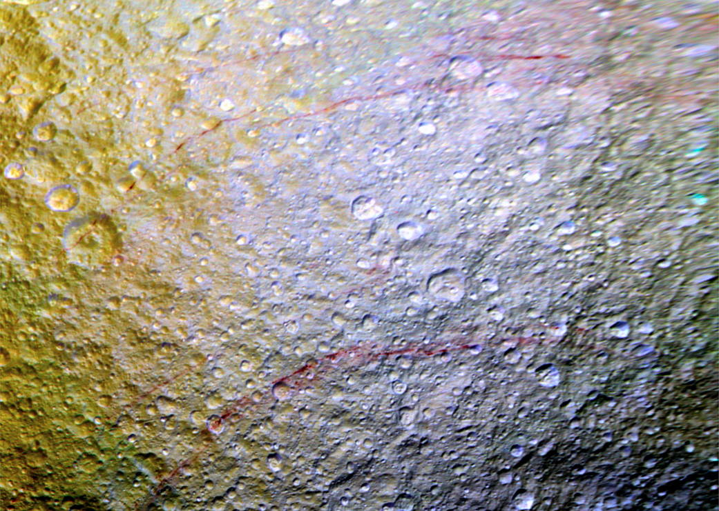 Unusual arc-shaped, reddish streaks cut across the surface of Saturn's ice-rich moon Tethys