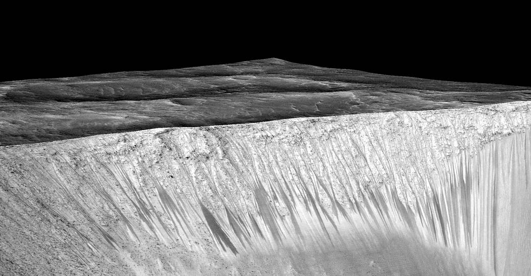 Dark narrow streaks, called "recurring slope lineae," emanate from the walls of Garni Crater on Mars