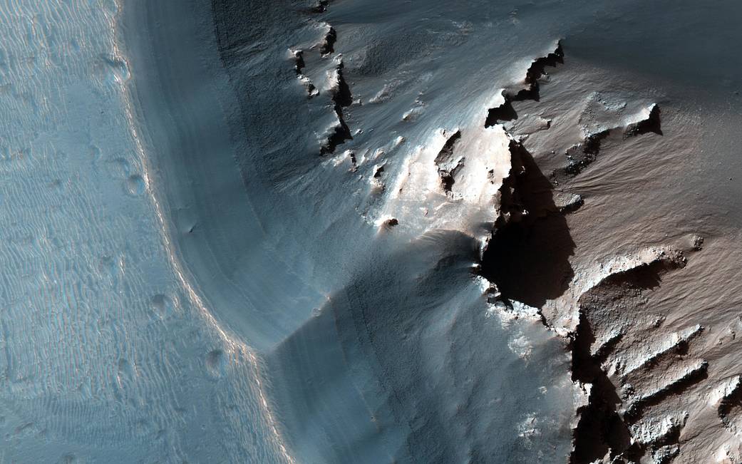 Light toned layered pit depression on surface of Mars