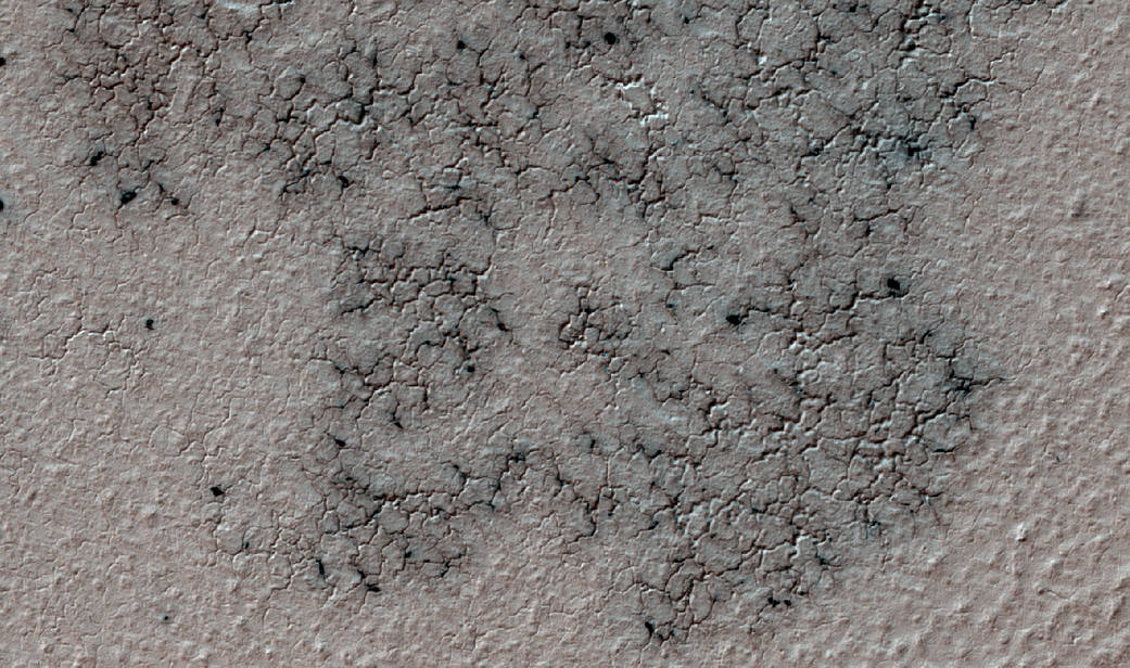 Spidery channels eroded into Martian ground